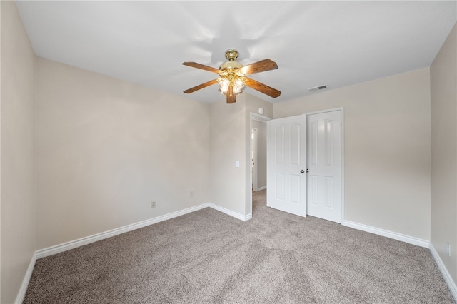 unfurnished bedroom featuring visible vents, a closet, baseboards, ceiling fan, and carpet