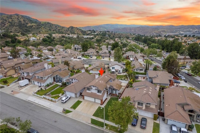 aerial view at dusk with a residential view and a mountain view