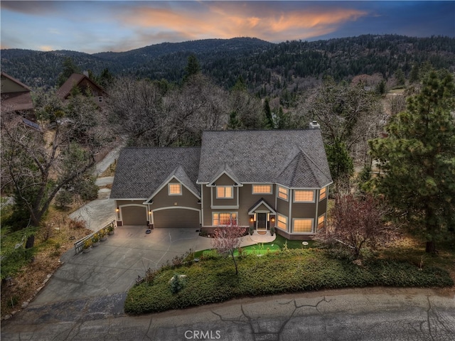 1010 Black Oaks Dr, Lake Arrowhead, CA 92352 - view of front of property featuring a garage, a forest view, driveway, and a mountain view