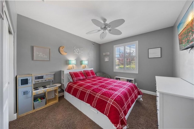 carpeted bedroom featuring a ceiling fan and baseboards