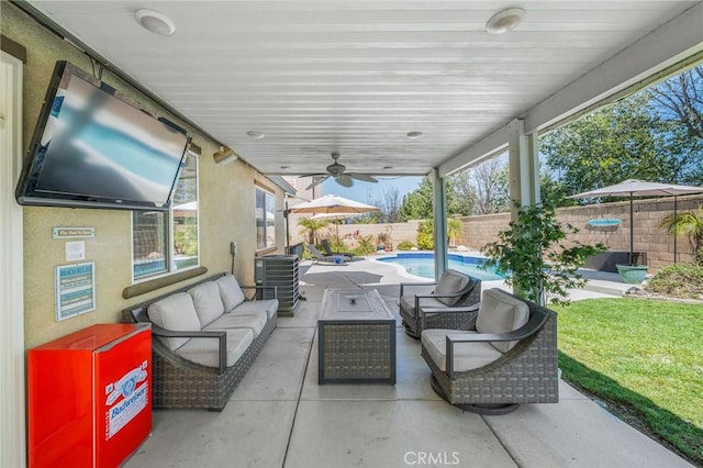 view of patio / terrace featuring central AC unit, a fenced in pool, ceiling fan, a fenced backyard, and outdoor lounge area