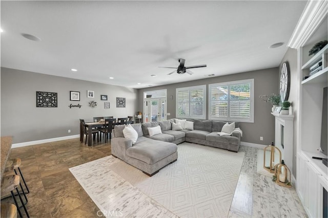 living room featuring recessed lighting, a ceiling fan, and baseboards