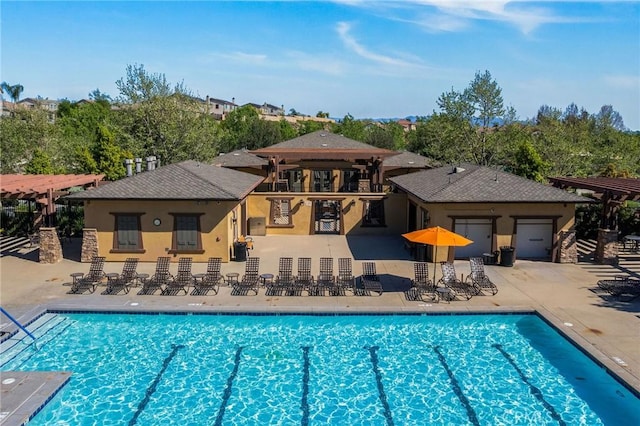 pool featuring an outdoor bar and a patio area