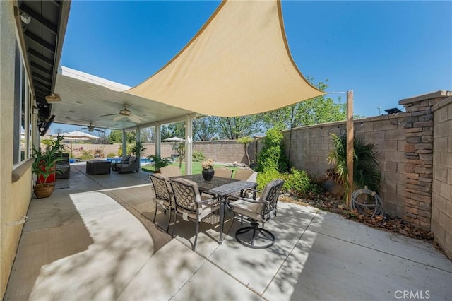 view of patio with outdoor dining space, a ceiling fan, outdoor lounge area, and a fenced backyard