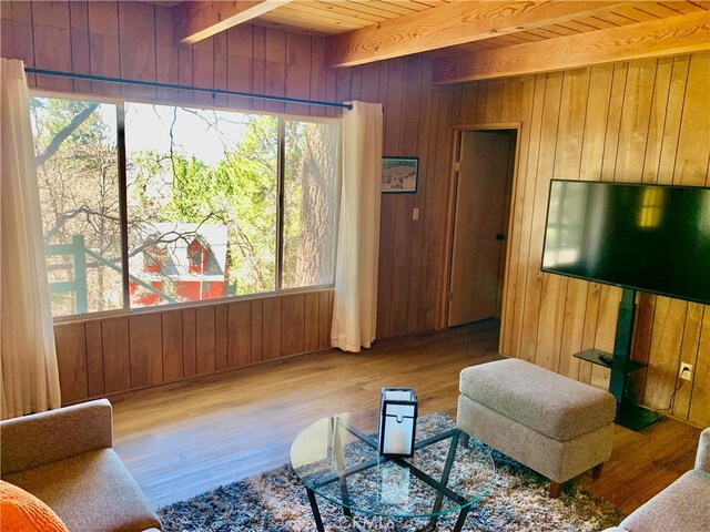 33010 Juniper Ln, Green Valley Lake, CA 92341 - living room featuring wood walls, wood finished floors, and beamed ceiling