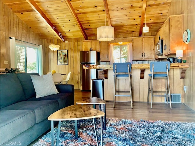 33010 Juniper Ln, Green Valley Lake, CA 92341 - living room featuring wood finished floors, beamed ceiling, wooden ceiling, wood walls, and visible vents