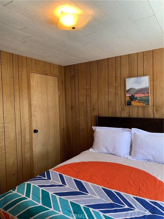 33010 Juniper Ln, Green Valley Lake, CA 92341 - bedroom featuring wood walls and a closet