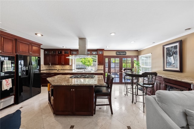1441 San Almada Rd, Corona, CA 92882 - kitchen with glass insert cabinets, black appliances, ornamental molding, island exhaust hood, and french doors