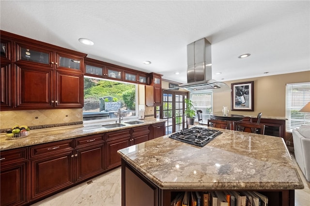 1441 San Almada Rd, Corona, CA 92882 - kitchen featuring a sink, decorative backsplash, island exhaust hood, gas cooktop, and dark brown cabinets