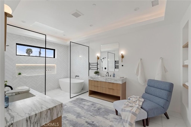 full bath with visible vents, tile patterned floors, a freestanding tub, and vanity