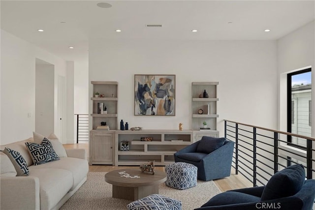 living area featuring light wood-type flooring, visible vents, and recessed lighting