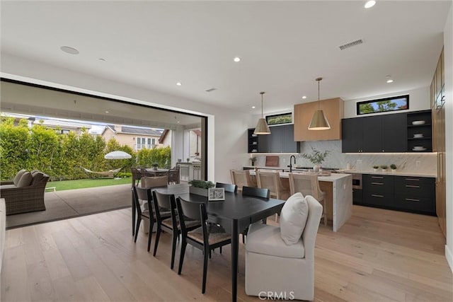 dining area featuring visible vents, recessed lighting, and light wood-style floors