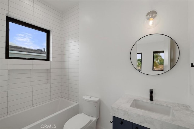 full bathroom featuring toilet, vanity, and plenty of natural light