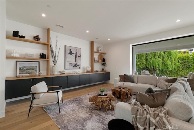 living area featuring visible vents, recessed lighting, and light wood-style floors