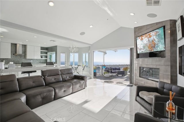 3 Via Pasa, San Clemente, CA 92673 - living room featuring marble finish flooring, recessed lighting, a chandelier, high vaulted ceiling, and a large fireplace