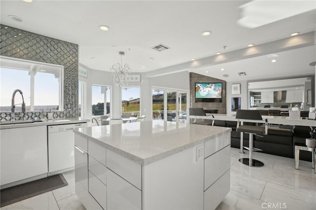 3 Via Pasa, San Clemente, CA 92673 - kitchen with modern cabinets, white dishwasher, recessed lighting, decorative backsplash, and white cabinetry