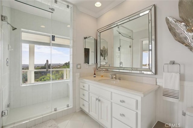 bathroom with vanity, tile patterned flooring, ornamental molding, and a shower stall