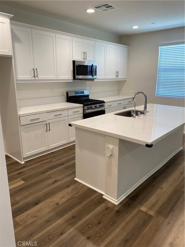 13110 Rosamond Ct, Hesperia, CA 92395 - kitchen featuring stainless steel appliances, a sink, white cabinets, dark wood-style floors, and light countertops