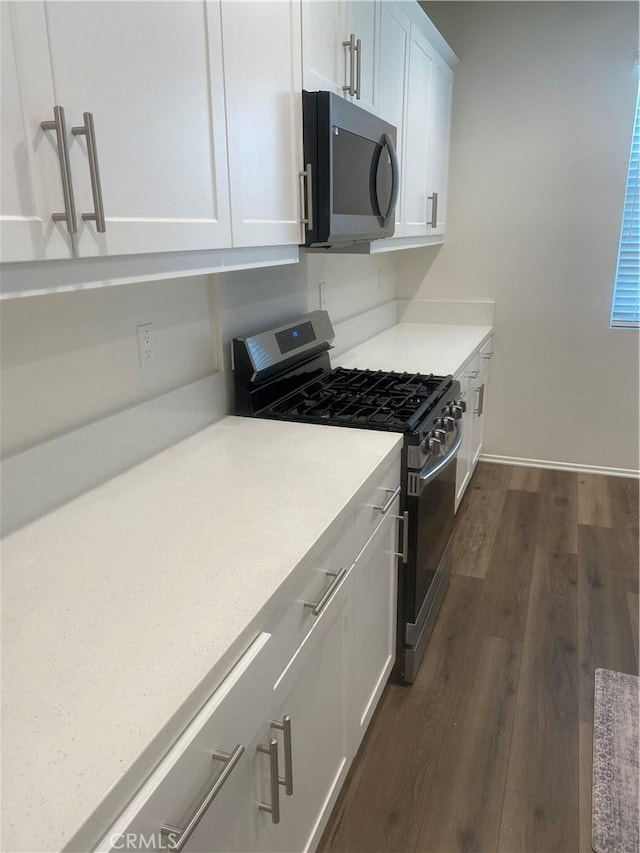 13110 Rosamond Ct, Hesperia, CA 92395 - kitchen featuring stainless steel range with gas cooktop, white cabinets, dark wood-style flooring, and light countertops