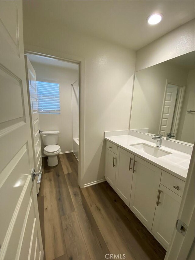 13110 Rosamond Ct, Hesperia, CA 92395 - bathroom with vanity, toilet, wood finished floors,  shower combination, and recessed lighting