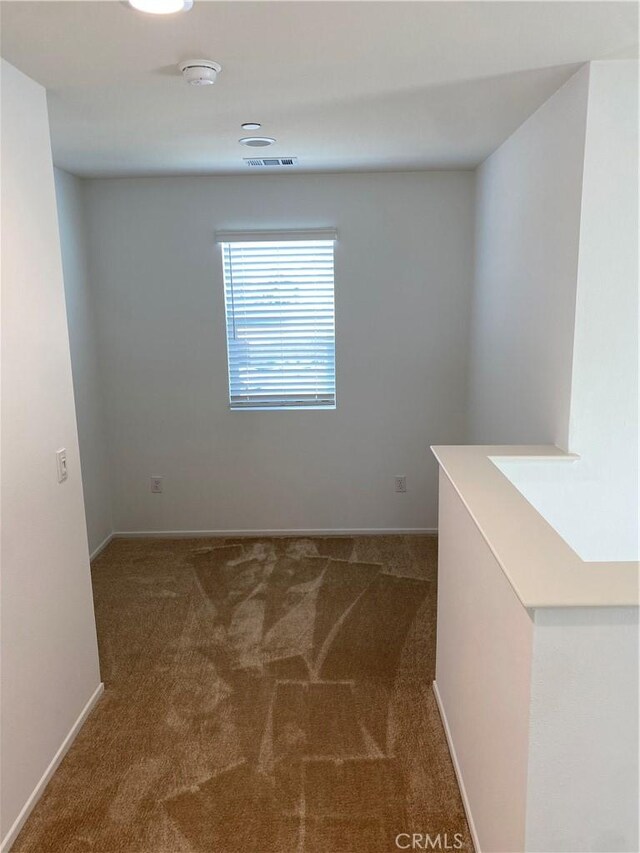 13110 Rosamond Ct, Hesperia, CA 92395 - carpeted empty room with baseboards and a smoke detector