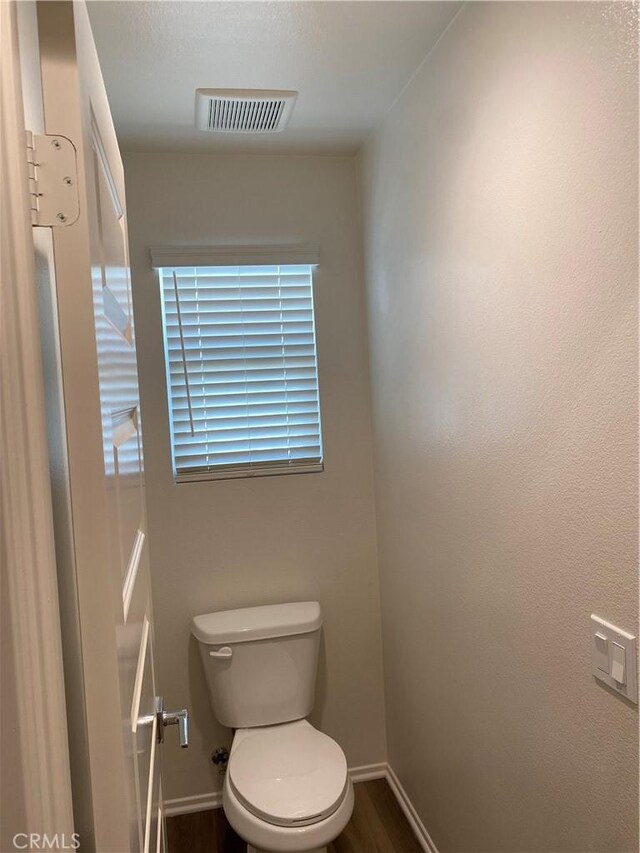 13110 Rosamond Ct, Hesperia, CA 92395 - bathroom featuring baseboards, toilet, and wood finished floors