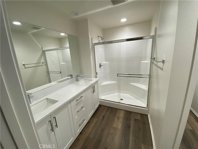 13110 Rosamond Ct, Hesperia, CA 92395 - full bath with a stall shower, wood finished floors, double vanity, and recessed lighting