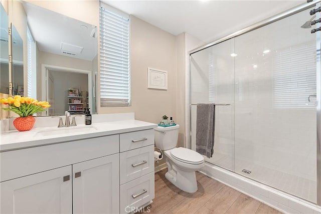 194 Tribeca, Irvine, CA 92612 - bathroom with vanity, wood finished floors, a shower stall, and toilet