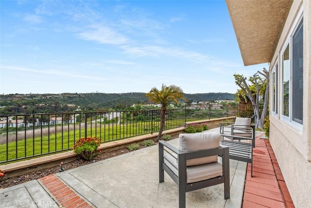 view of patio / terrace with a fenced backyard and a mountain view