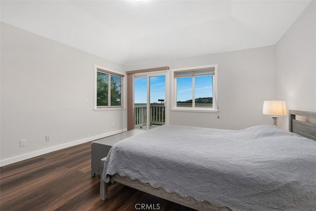 bedroom with wood finished floors, baseboards, and access to outside