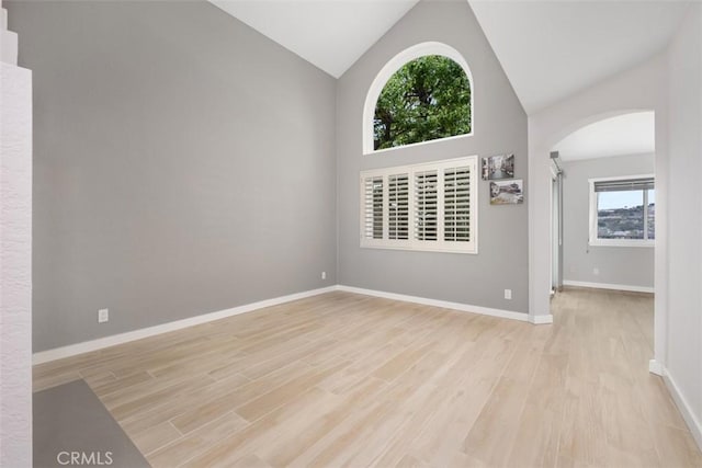23875 Catamaran Way Unit 51, Laguna Niguel, CA 92677 - unfurnished room featuring high vaulted ceiling, arched walkways, and light wood-style floors