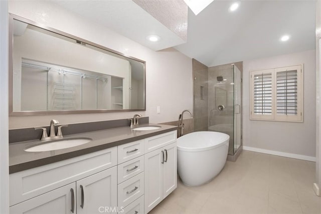23875 Catamaran Way Unit 51, Laguna Niguel, CA 92677 - full bathroom featuring a shower stall, double vanity, a freestanding tub, recessed lighting, and a textured ceiling