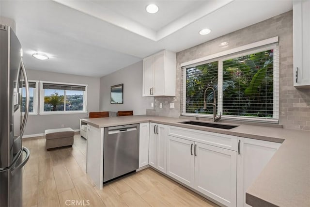 23875 Catamaran Way Unit 51, Laguna Niguel, CA 92677 - kitchen with stainless steel appliances, white cabinets, decorative backsplash, light countertops, and recessed lighting