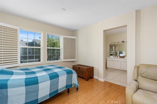 37 Rumford St, Ladera Ranch, CA 92694 - bedroom with light wood-style floors, baseboards, and connected bathroom