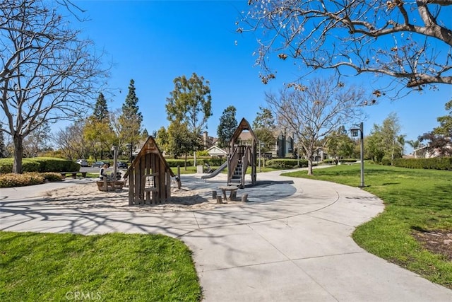 view of community featuring playground community and a yard