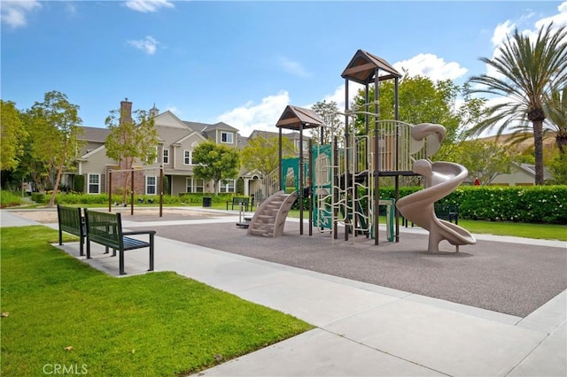 community play area featuring a yard and a residential view