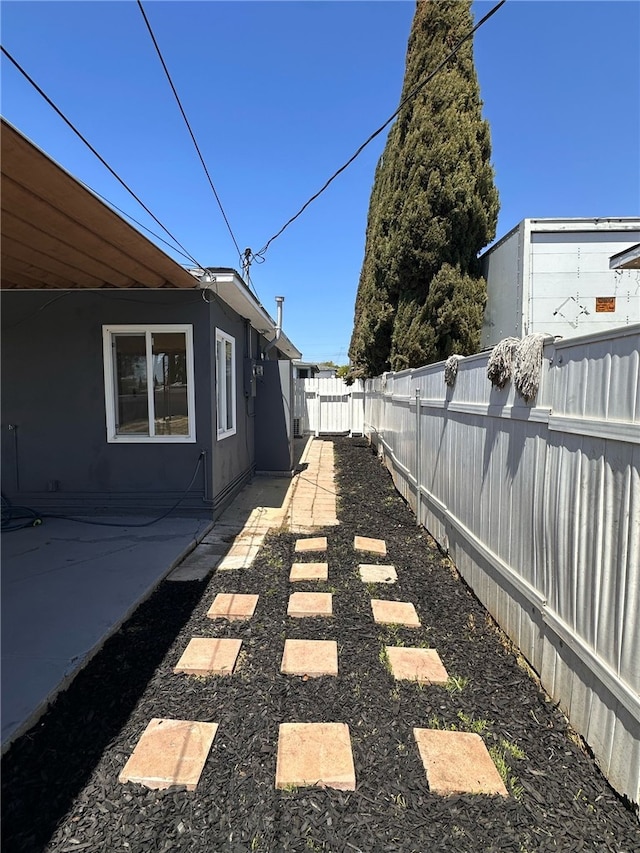 view of property exterior featuring a patio and a fenced backyard