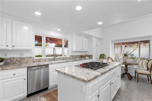 31 Terraza Del Mar, Dana Point, CA 92629 - kitchen with stainless steel appliances, healthy amount of natural light, a center island, light stone countertops, and recessed lighting