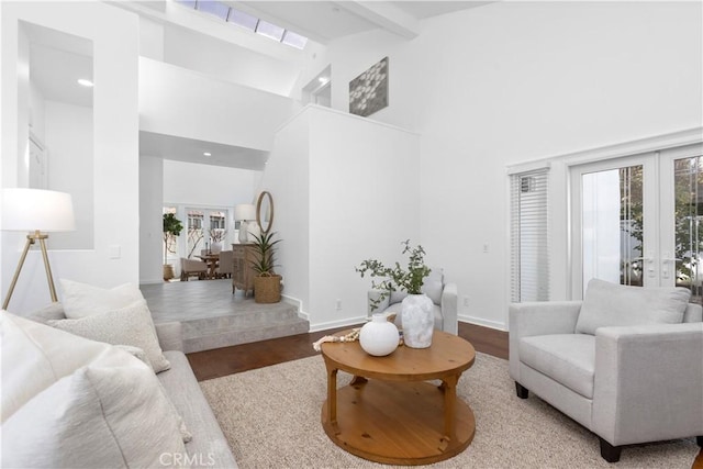 31 Terraza Del Mar, Dana Point, CA 92629 - living room featuring french doors, wood finished floors, beam ceiling, high vaulted ceiling, and recessed lighting