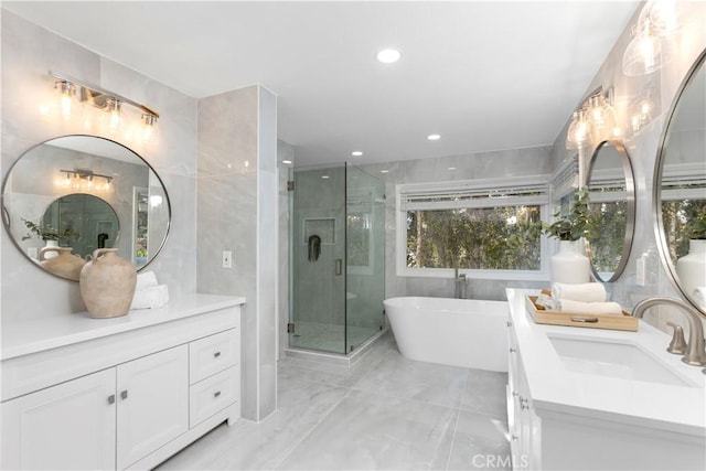 31 Terraza Del Mar, Dana Point, CA 92629 - full bath featuring vanity, marble tiled floors, a soaking tub, a stall shower, and tile walls