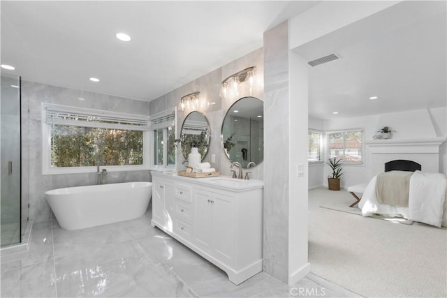 31 Terraza Del Mar, Dana Point, CA 92629 - ensuite bathroom with double vanity, a freestanding tub, recessed lighting, marble finish floors, and baseboards