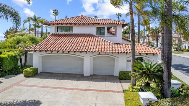 31 Terraza Del Mar, Dana Point, CA 92629 - mediterranean / spanish-style house featuring stucco siding, a garage, a tile roof, and driveway