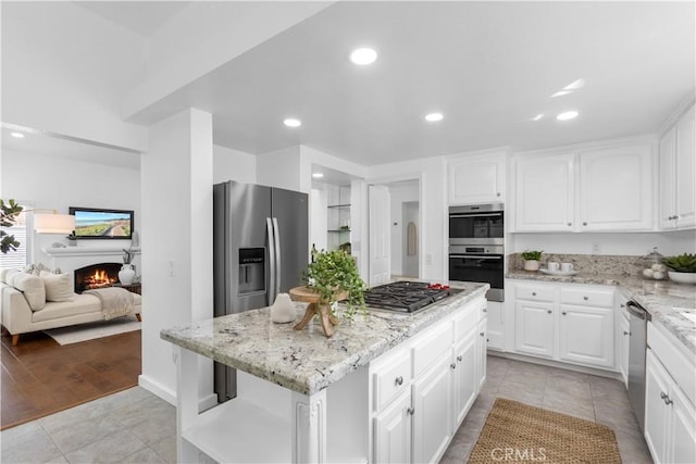 31 Terraza Del Mar, Dana Point, CA 92629 - kitchen with a center island, light stone countertops, white cabinetry, appliances with stainless steel finishes, and recessed lighting