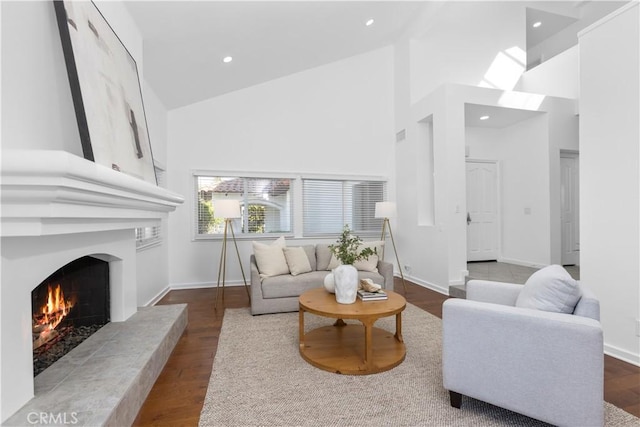 31 Terraza Del Mar, Dana Point, CA 92629 - living area with high vaulted ceiling, a large fireplace, dark wood-type flooring, baseboards, and recessed lighting