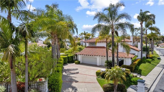 31 Terraza Del Mar, Dana Point, CA 92629 - mediterranean / spanish home featuring driveway, stucco siding, a tiled roof, and an attached garage