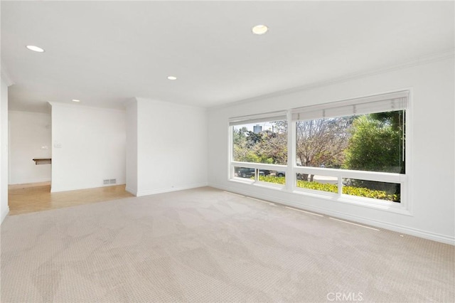 empty room with recessed lighting, visible vents, light colored carpet, and baseboards