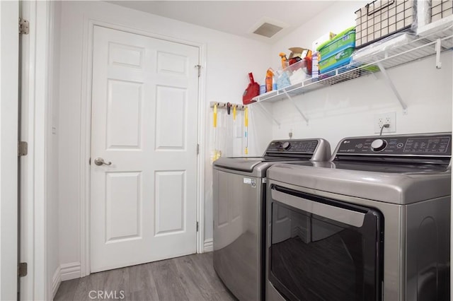 7744 Rhea Ave, Reseda, CA 91335 - laundry room featuring washing machine and dryer, wood finished floors, and baseboards