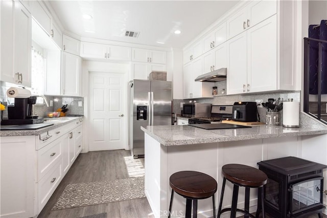 7744 Rhea Ave, Reseda, CA 91335 - kitchen with appliances with stainless steel finishes, a peninsula, under cabinet range hood, white cabinets, and recessed lighting