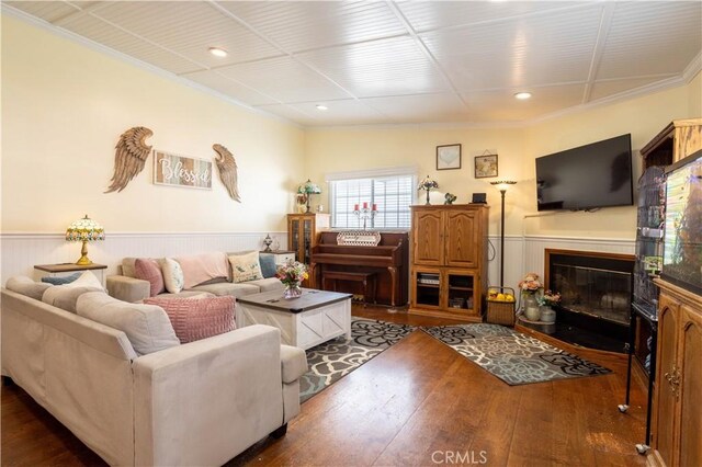 7744 Rhea Ave, Reseda, CA 91335 - living room featuring wood-type flooring, wainscoting, crown molding, a glass covered fireplace, and recessed lighting