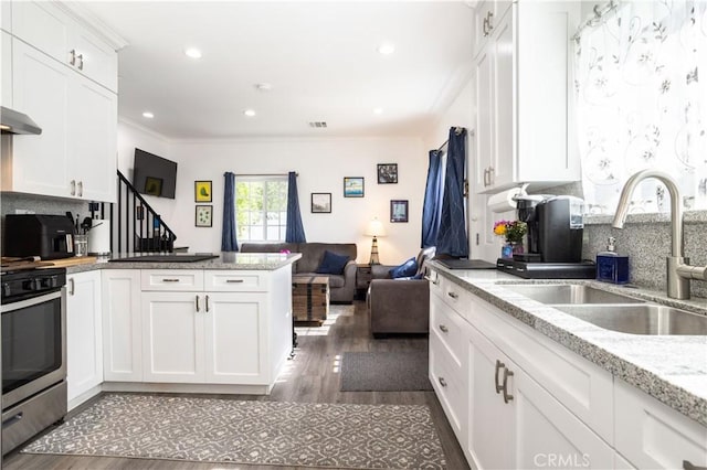 7744 Rhea Ave, Reseda, CA 91335 - kitchen with a sink, stainless steel range, wood finished floors, a peninsula, and open floor plan